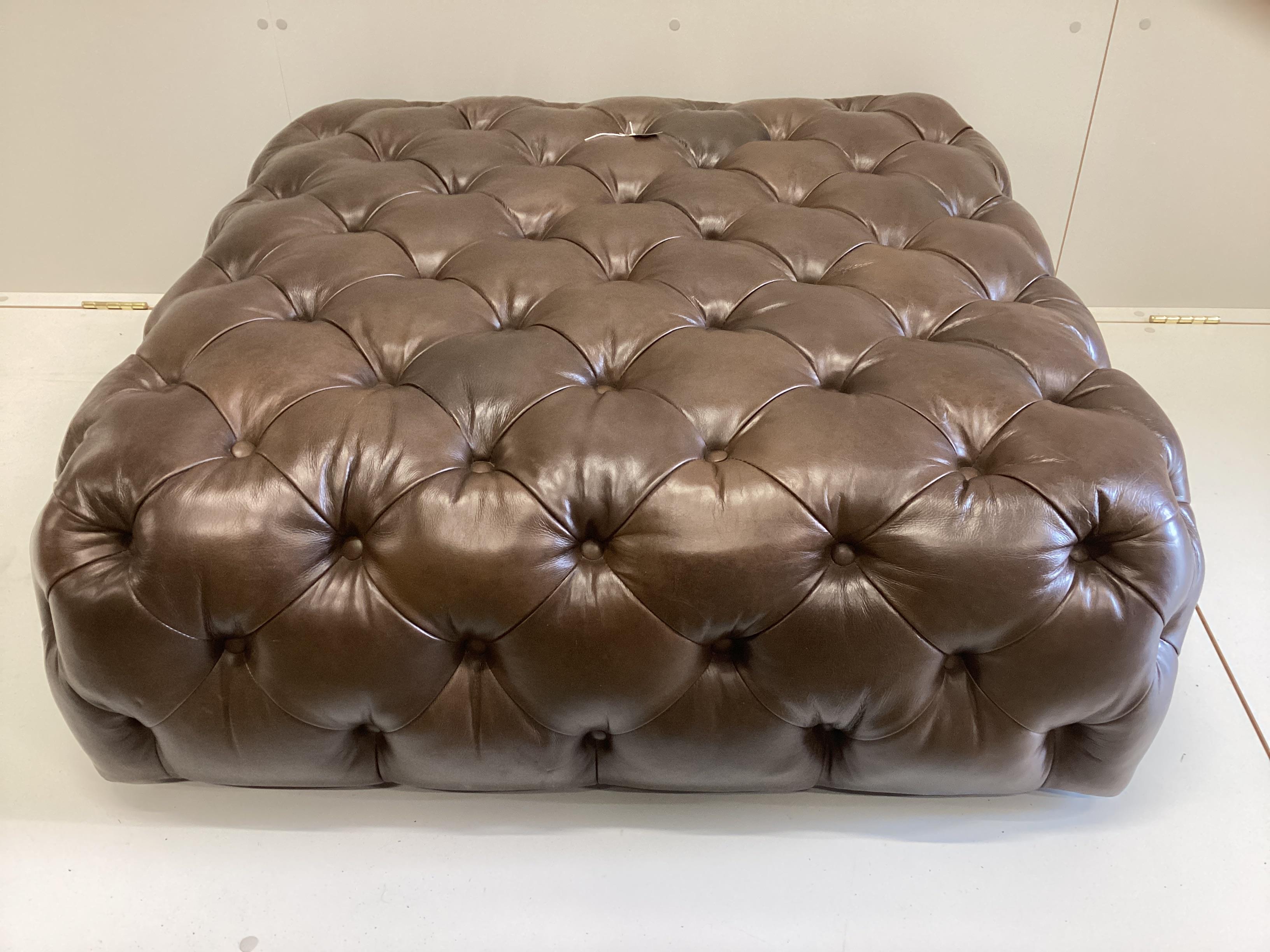 A large contemporary Victorian style buttoned brown leather footstool, originally retailed by Cox & Cox, width 104cm, depth 100cm, height 38cm